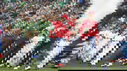 Babar Azam and Jos Buttler lead their teams out for the national anthems
