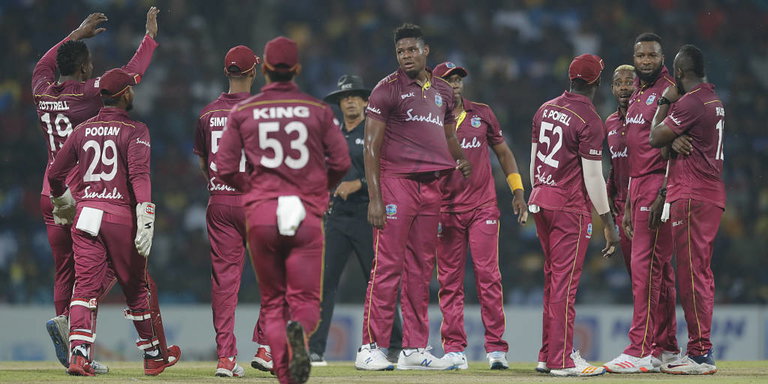 West Indies' bowler Oshane Thomas, center, celebrates the dismissal of Sri Lanka's Dasun Shanaka with team mates during their first Twenty20 cricket match in Pallekele, Sri Lanka, Wednesday, March 4, 2020. (AP Photo/Eranga Jayawardena)