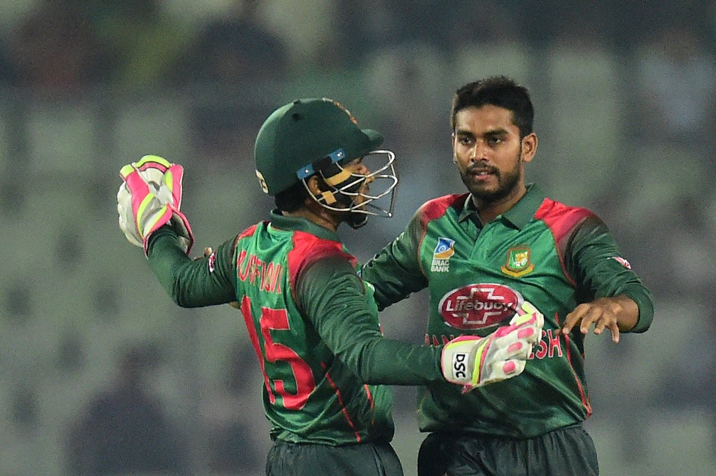 BangladeshI cricketer Mehidy Hasan (R) celebrates with teammate Mushfiqur Rahim (L) (Photo by MUNIR UZ ZAMAN / AFP)