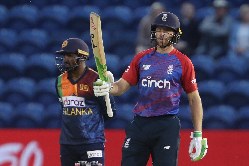 England's Jos Buttler celebrates his half-century during the first T20I between England and Sri Lanka at Cardiff Wales Stadium in Cardiff, Wales on June 23, 2021. (Photo by Geoff Caddick / AFP)