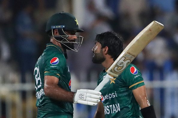 Pakistan's Fakhar Zaman (L) celebrates with teammate Mohammad Rizwan afer scoring his half-century (50 runs) during the Asia Cup Twenty20 international cricket match between Pakistan and Hong Kong at the Sharjah Cricket Stadium in Sharjah on September 2, 2022. (Photo by Surjeet Yadav / AFP) (Photo by SURJEET YADAV/AFP via Getty Images)