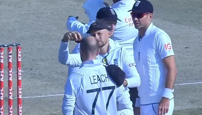 Joe Root is shining the ball on Jack Leach's head