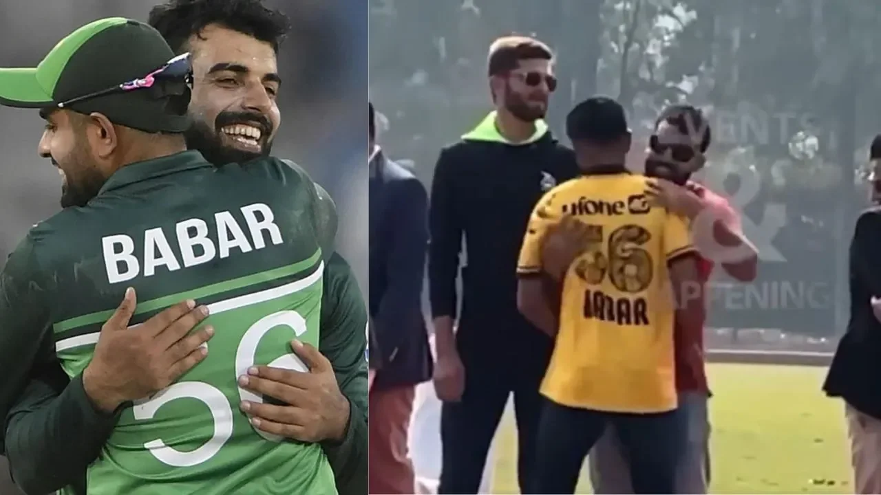 Shadab Khan wipes his hand on Babar Azam's jersey